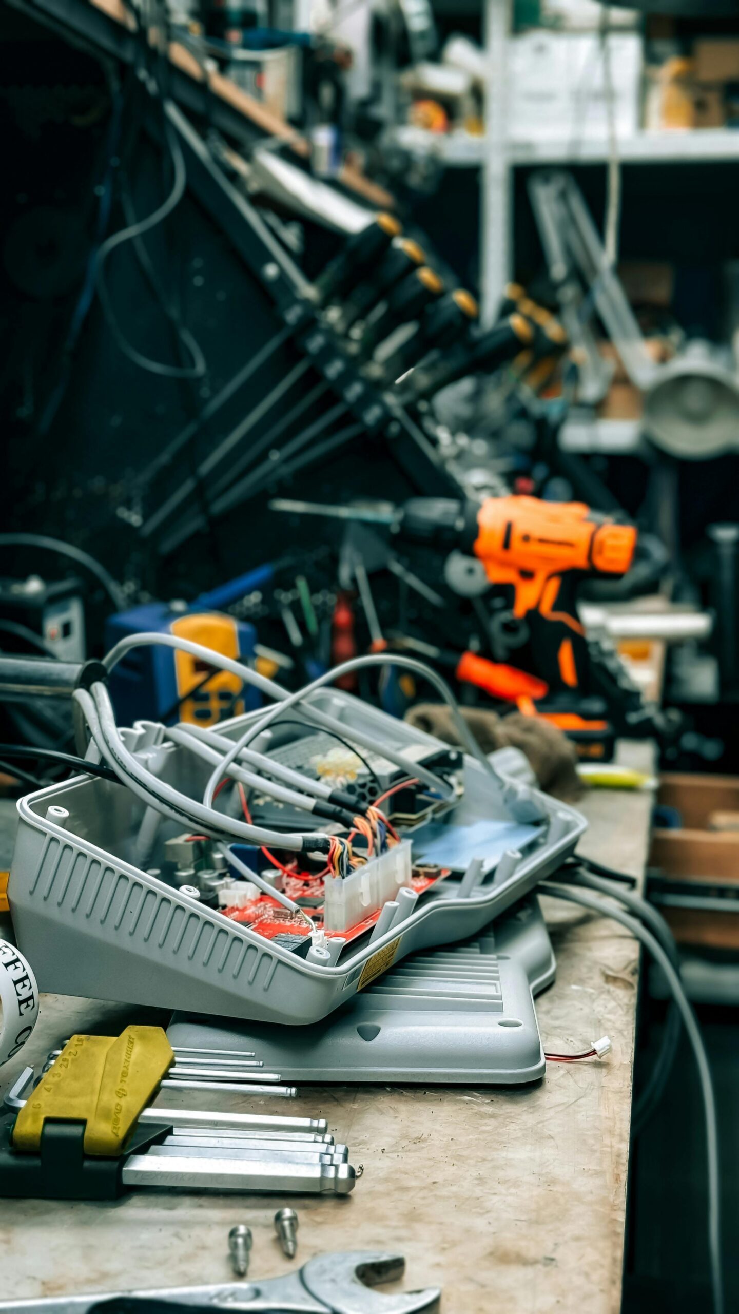 Workshop bench with electronic equipment and tools showcasing a repair environment.